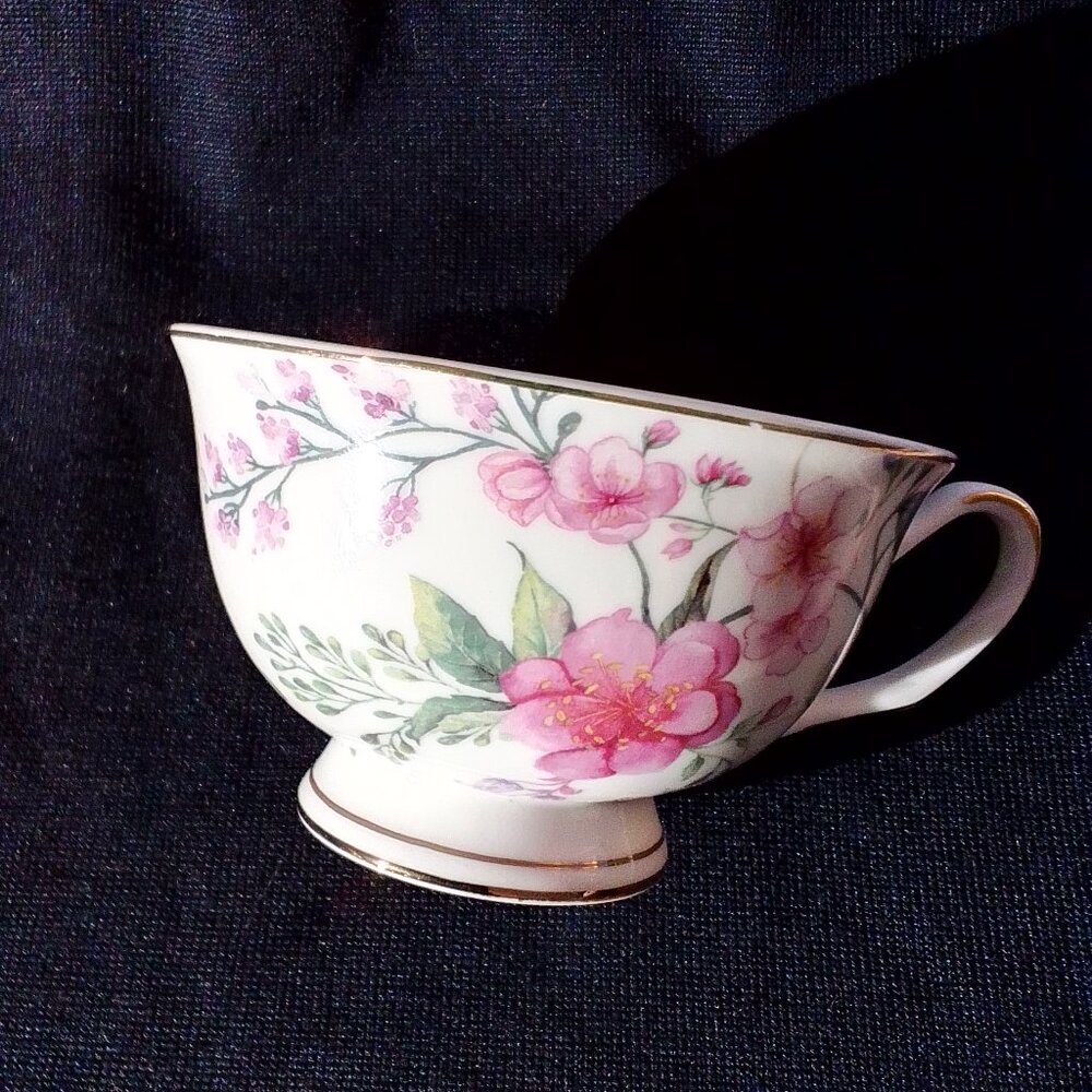 Shabby chic teacup and saucer. Floral detail